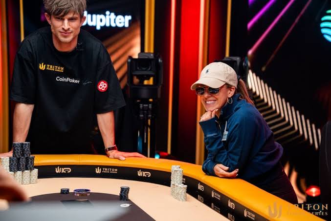 Two players at a Triton Poker Series broadcast table with a gold rail and studio lighting